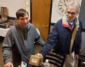 Mark, KC8ESG,, checks out the radio Scott, AC8NW, won.